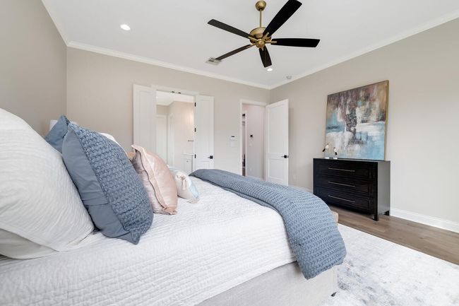 Bedroom with wood finished floors, recessed lighting, ornamental molding, and ceiling fan | Image 27