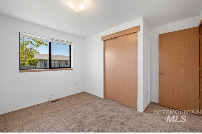 Unfurnished bedroom with carpet flooring and a closet | Image 15