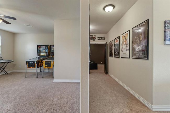A view down the hall towards the media room and the spacious game room. | Image 36