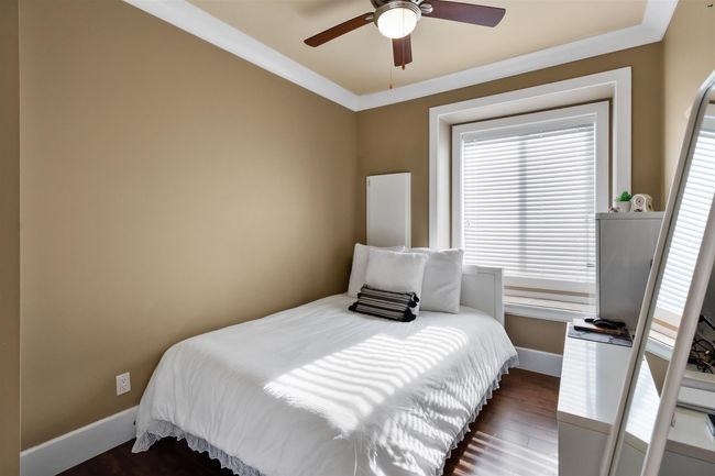 Bedroom featuring baseboards, wood finished floors, and ceiling fan | Image 27