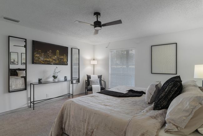 Carpeted bedroom with a textured ceiling, visible vents, and ceiling fan | Image 27