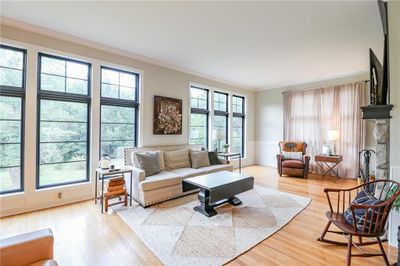 Living room with light hardwood / wood-style flooring and crown molding | Image 3