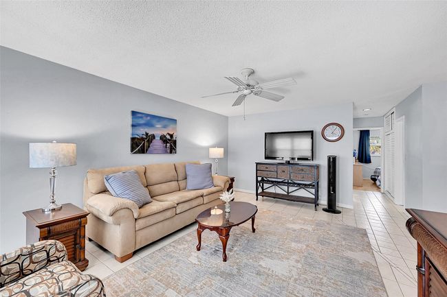 Your Furnished Living Room includes a Queen Sized Sofa Bed, Impact Windows and Doors with Blinds and Retractable Screen Doors! Bright, Open, Spacious and Ready for You and Your Family and Friends to Enjoy! | Image 26