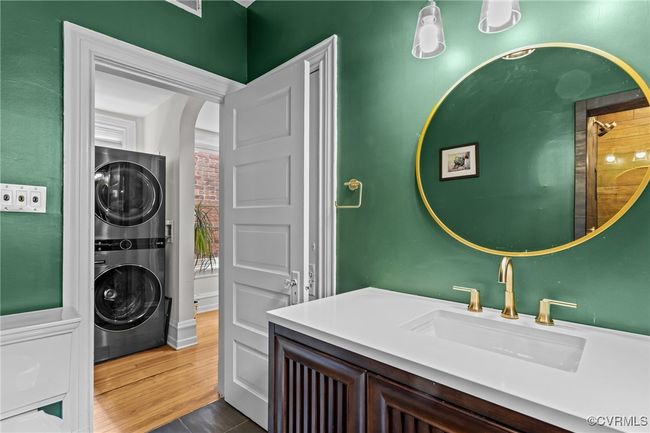 Clothes washing area with stacked washer / dryer, a sink, and laundry area | Image 27