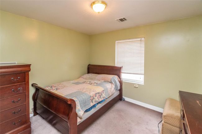 Bedroom with visible vents, light colored carpet, and baseboards | Image 38
