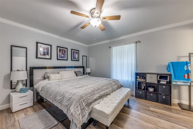 Bedroom featuring wood finished floors, ornamental molding, and ceiling fan | Image 14