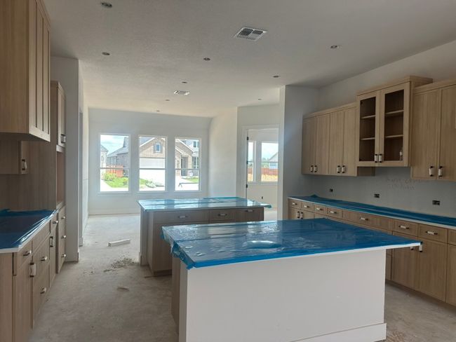 Kitchen with a kitchen island, light brown cabinetry, and unfinished concrete​​‌​​​​‌​​‌‌​‌‌​​​‌‌​​‌‌​‌​​​​​‌ floors | Image 4