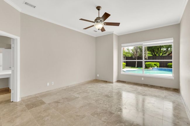 Spare room featuring ornamental molding, baseboards, a ceiling fan, and visible vents | Image 17