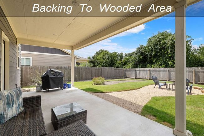 Fenced backyard with a patio area and grilling area | Image 29