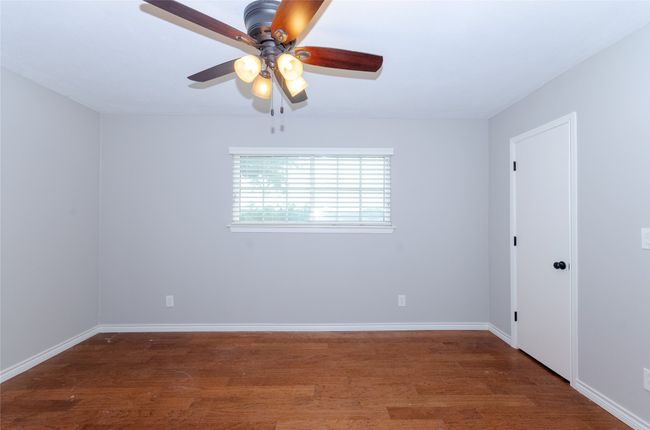 Bedroom with dark wood-type flooring and ceiling fan | Image 21