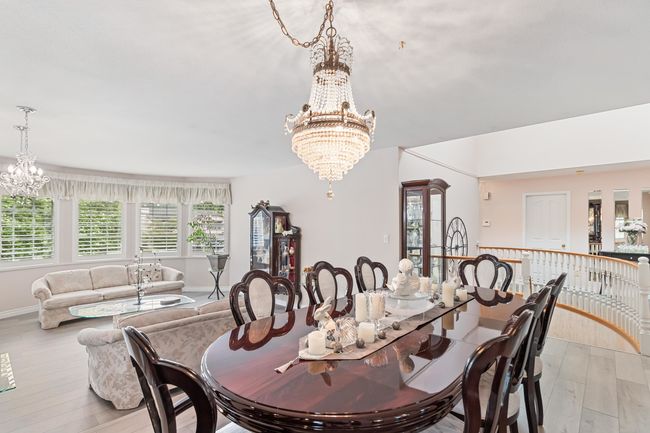 Dining area featuring a chandelier, light wood finished floors, and baseboards | Image 7
