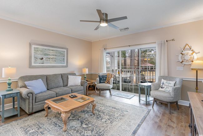 Living room featuring ceiling fan, ornamental molding, and hardwood / wood-style flooring | Image 4