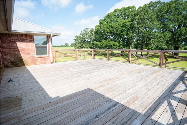 Wooden deck with a lawn | Image 8
