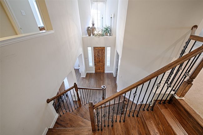 Foyer entrance with stairs, a towering ceiling, baseboards, and wood finished floors | Image 21