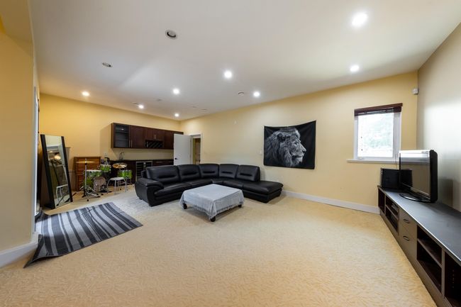 Living room with light colored carpet, recessed lighting, and baseboards | Image 18