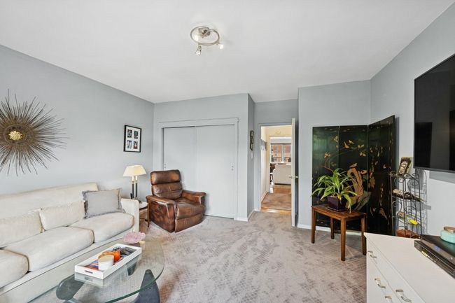 Living room featuring light colored carpet and baseboards | Image 16