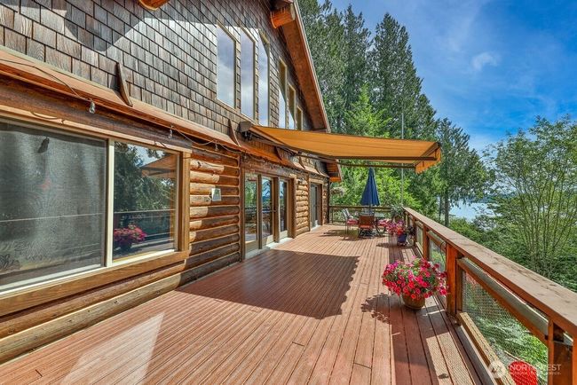 Huge wrap-around trex deck perfect for entertaining and relaxing with a water view! | Image 23