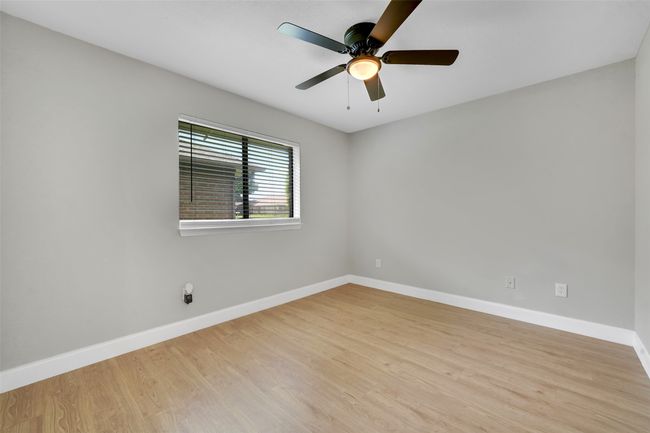 Empty room with wood finished floors and ceiling fan | Image 18