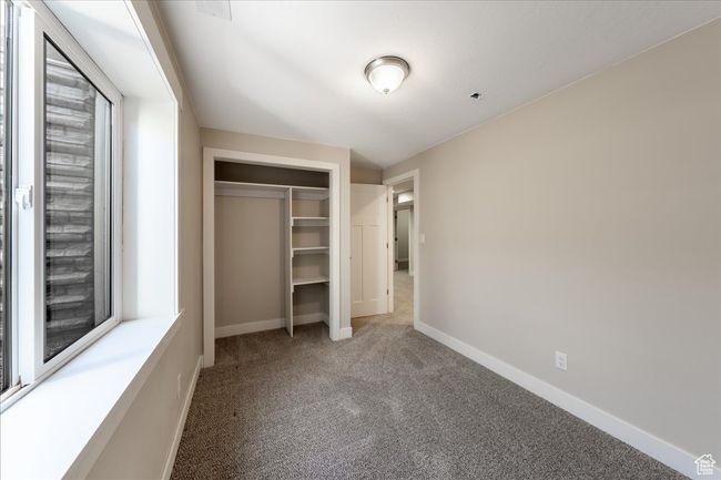 Unfurnished bedroom featuring baseboards, carpet flooring, and a closet | Image 44