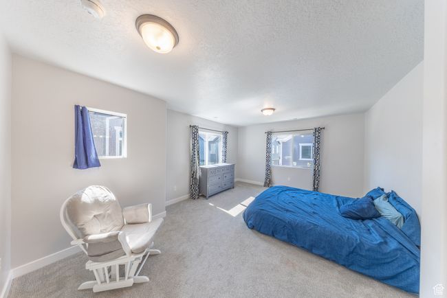 Large master bedroom featuring lots of windows, and carpet flooring. Lots of space. | Image 12