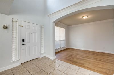 Foyer entrance with ornamental molding and light wood-type flooring | Image 3