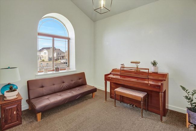 Living area with vaulted ceiling, baseboards, and carpet | Image 8