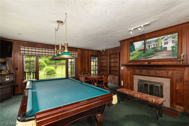 Playroom featuring wooden walls, billiards, and dark colored carpet | Image 20