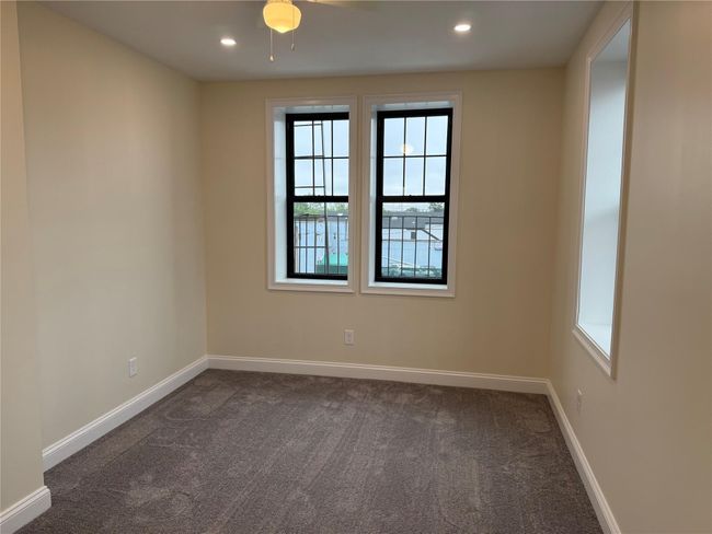 Spare room with plenty of natural light, dark carpet, and recessed lighting | Image 6