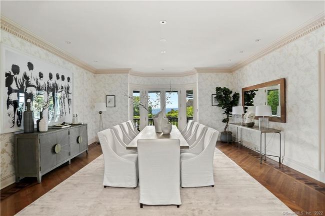 DINING ROOM // Enter this stunning space through the quarter sawn oak archway with custom pocket doors to water views immediately in sight through the French doors. Access kitchen through butler�s pantry with sink and Marvel wine cooler. | Image 5