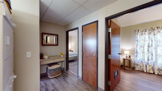 Hallway featuring wood finished floors and a paneled ceiling | Image 10