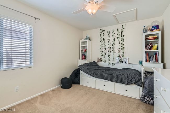 Bedroom with carpet flooring, baseboards, attic access, and ceiling fan | Image 23