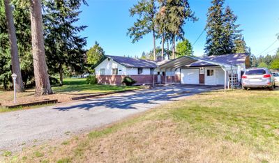 Cute rambler with covered parking for 2 cars, RV parking and room for all the toys | Image 1