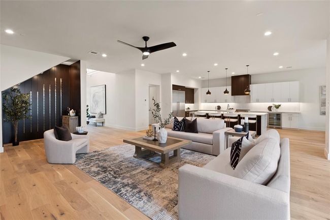 Open living area with wine wall and spacious kitchen with luxury appliance including wine cooler | Image 7
