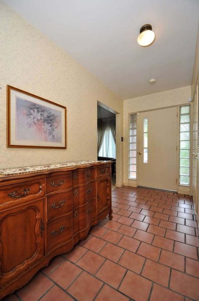 This wall of cupboards is a coat closet as well as a pantry area. | Image 7