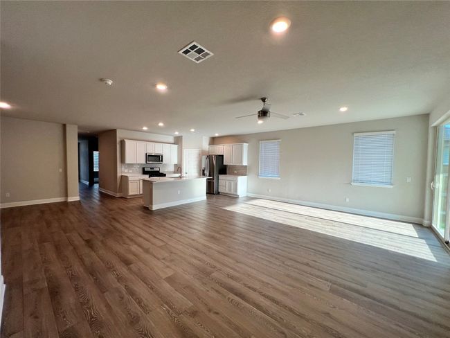 Unfurnished living room with recessed lighting, dark wood finished floors, and ceiling fan | Image 7