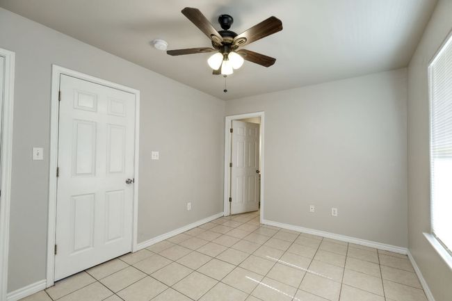 Spare room featuring ceiling fan and light tile patterned floors | Image 11