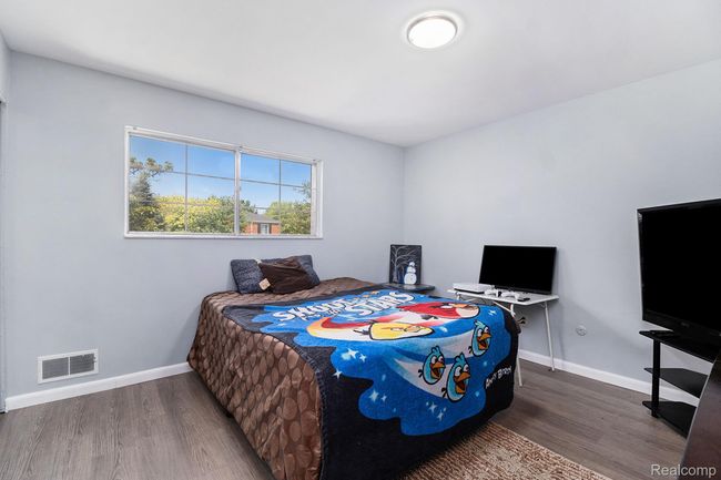 Bedroom with dark wood-style floors and baseboards | Image 14
