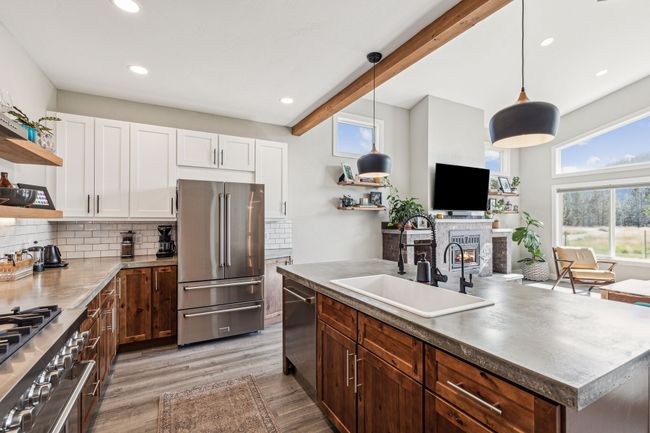 Kitchen with stainless steel appliances, open shelves, a sink, white cabinets, and recessed lighting | Image 21