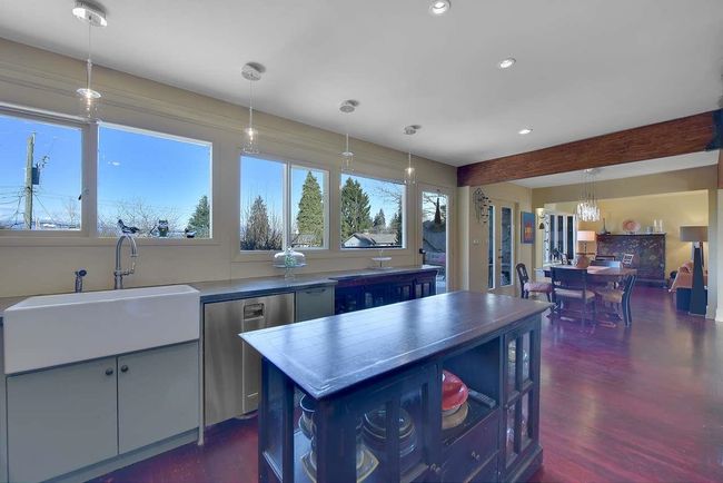 Kitchen featuring healthy amount of natural light, recessed lighting, decorative light fixtures, dark wood finished floors, and a kitchen island | Image 16