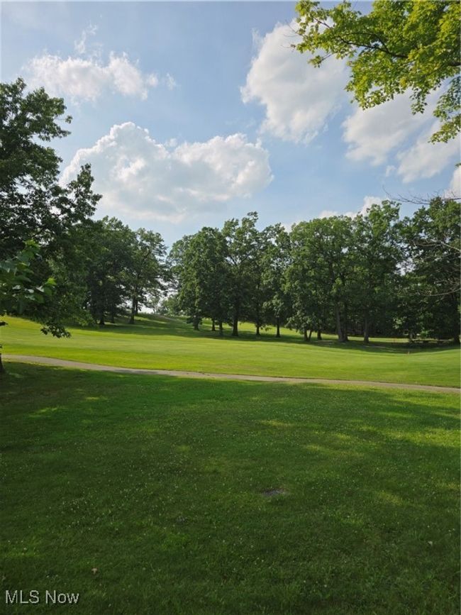 View of property's community with a lawn and view of golf course | Image 28