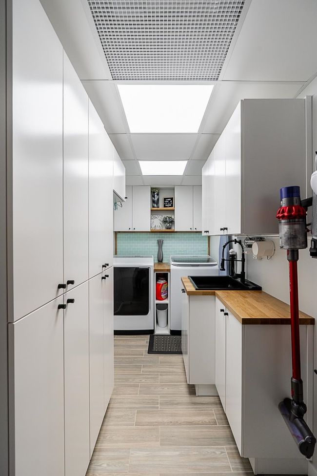 Kitchen featuring wood counters, a sink, open shelves, and white cabinetry | Image 32