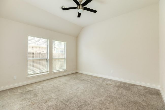 The secondary bedroom faces the front of the home. | Image 7