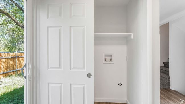 Laundry room featuring wood finished floors, washer hookup, and laundry area | Image 9