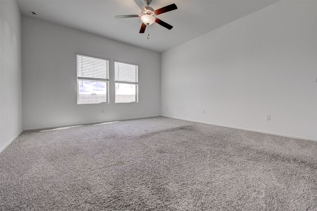 Carpeted spare room with ceiling fan and baseboards | Image 14