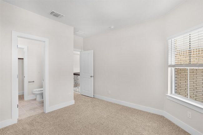 Unfurnished bedroom with carpet flooring, baseboards, and ensuite bath | Image 21