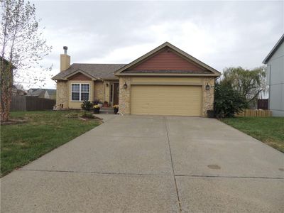 View of front of home with a front lawn and a garage | Image 1