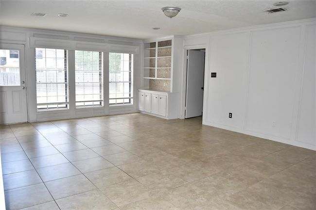 very large living room with built in storage | Image 7
