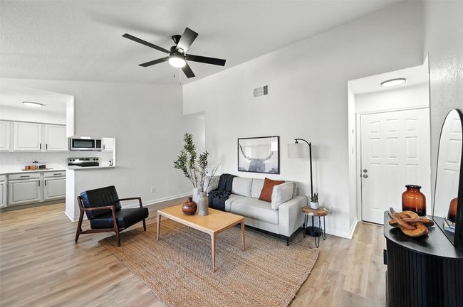Living room featuring light wood-type flooring and a ceiling fan | Image 6