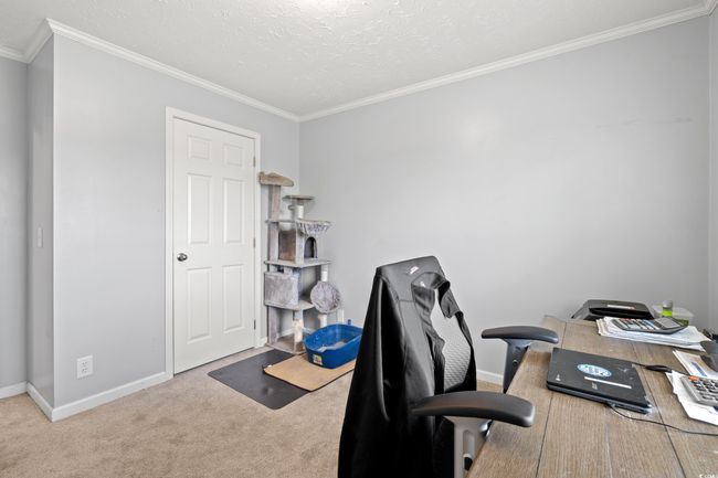 Office area featuring crown molding, carpet flooring, and a textured ceiling | Image 22