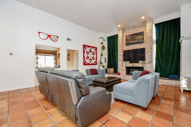 Even a space as large as this, can be made cozy with your placement of furnishings. Picture this area filled with family and friends at holiday time, gathering close to the wood burning fireplace. | Image 14